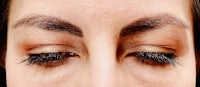 a close up of a woman's eyes with long lashes